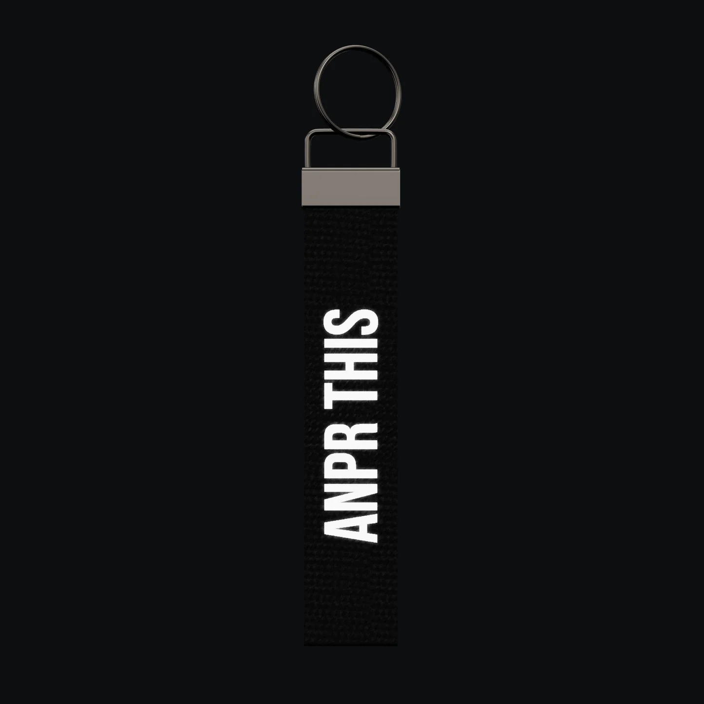 ANPR THIS Keychain, reflective print lit up by a camera flash