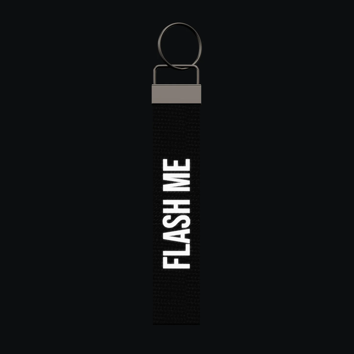 FLASH ME Keychain, reflective print lit up by a camera flash