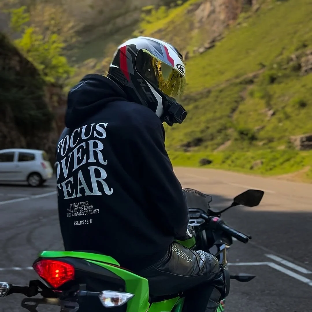 Rider wearing the FOCUS OVER FEAR Hoodie, back print