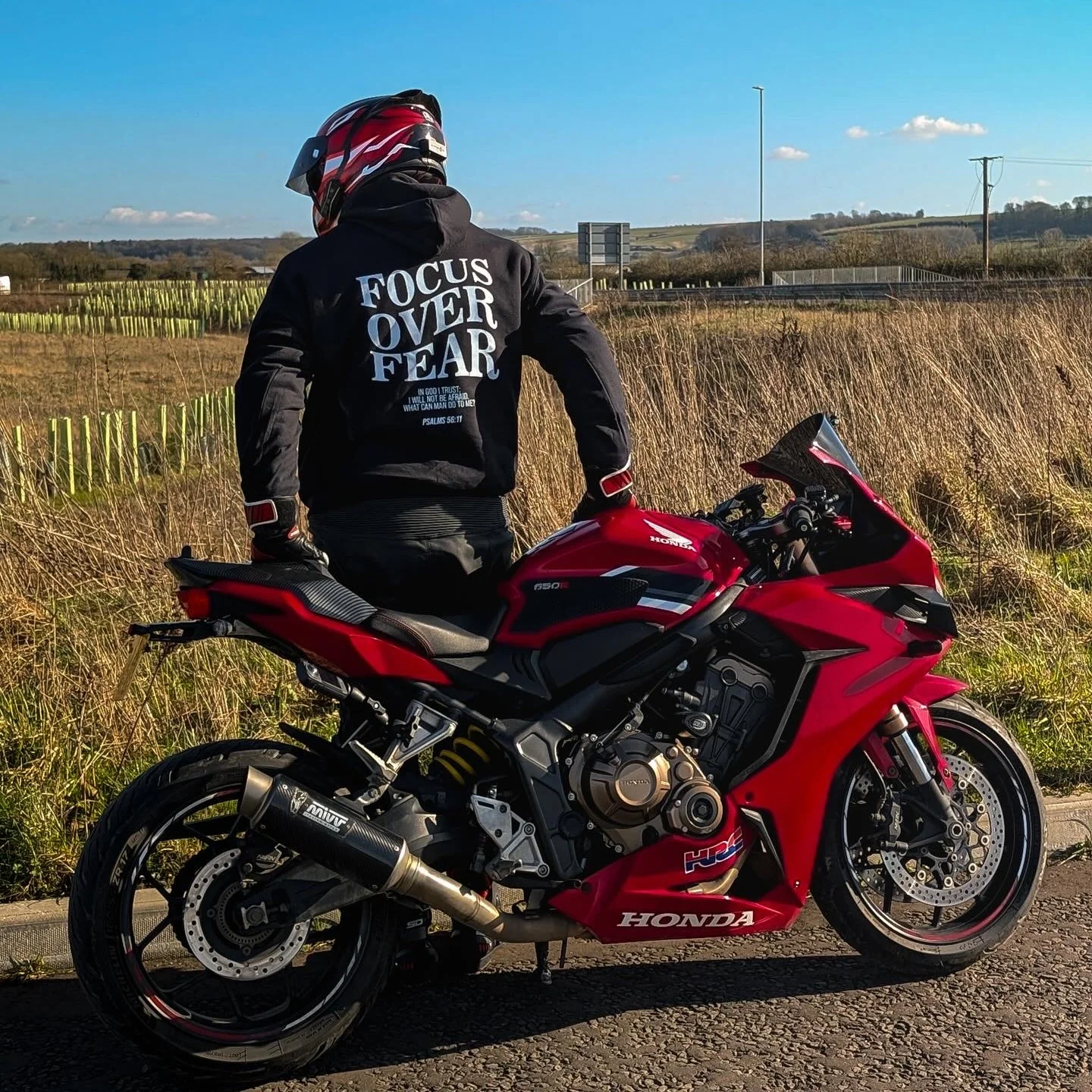 Rider wearing the FOCUS OVER FEAR Hoodie, back print