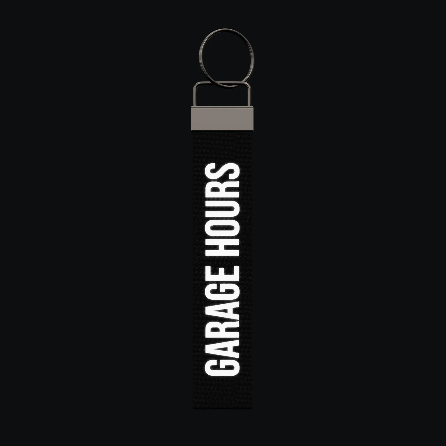 GARAGE HOURS Keychain, reflective print lit up by a camera flash