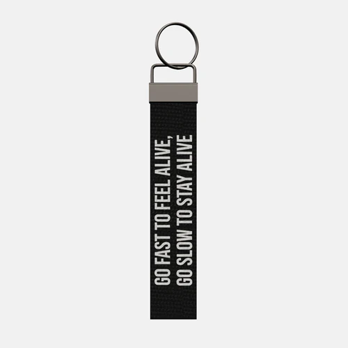 GO FAST TO FEEL ALIVE, GO SLOW TO STAY ALIVE Keychain, front: GO FAST TO FEEL ALIVE, GO SLOW TO STAY ALIVE in white print