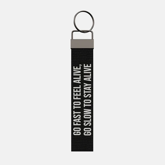 GO FAST TO FEEL ALIVE, GO SLOW TO STAY ALIVE Keychain, front: GO FAST TO FEEL ALIVE, GO SLOW TO STAY ALIVE in white print
