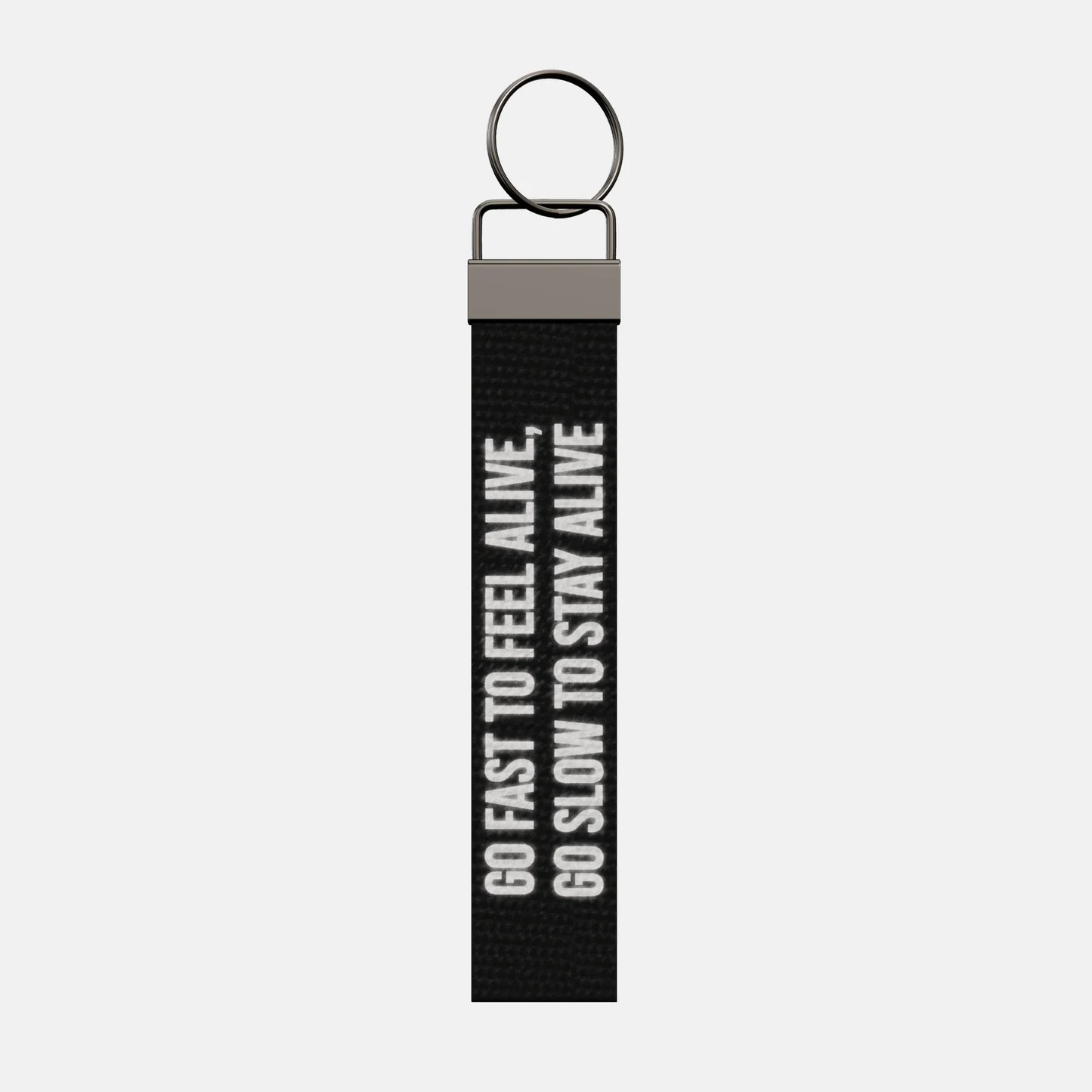 GO FAST TO FEEL ALIVE, GO SLOW TO STAY ALIVE Keychain, front: GO FAST TO FEEL ALIVE, GO SLOW TO STAY ALIVE in reflective print