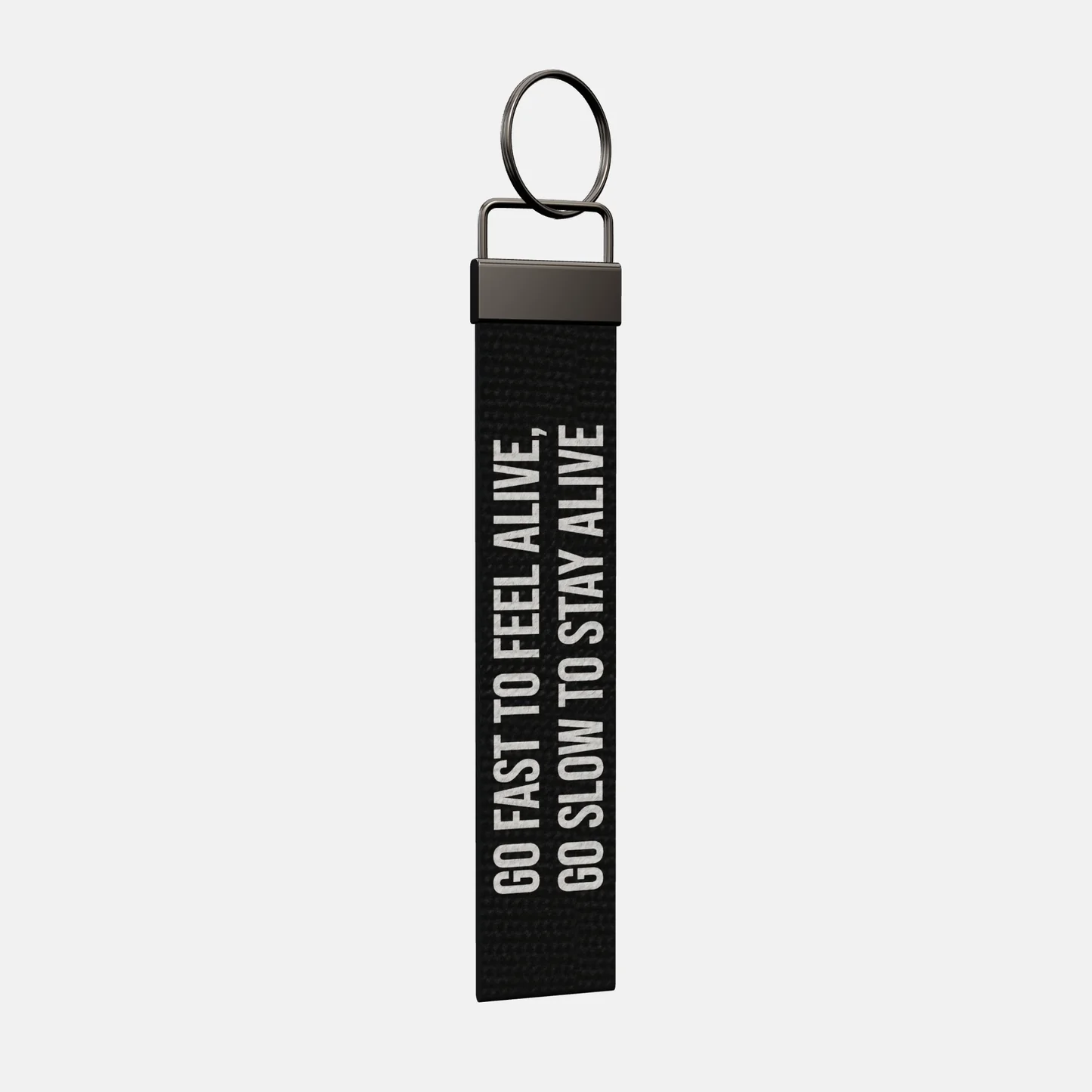 GO FAST TO FEEL ALIVE, GO SLOW TO STAY ALIVE Keychain at an angle, black-nickel clamp and split ring
