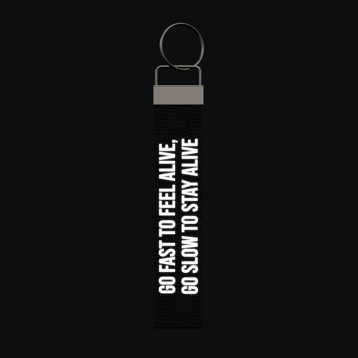 GO FAST TO FEEL ALIVE, GO SLOW TO STAY ALIVE Keychain, reflective print lit up by a camera flash