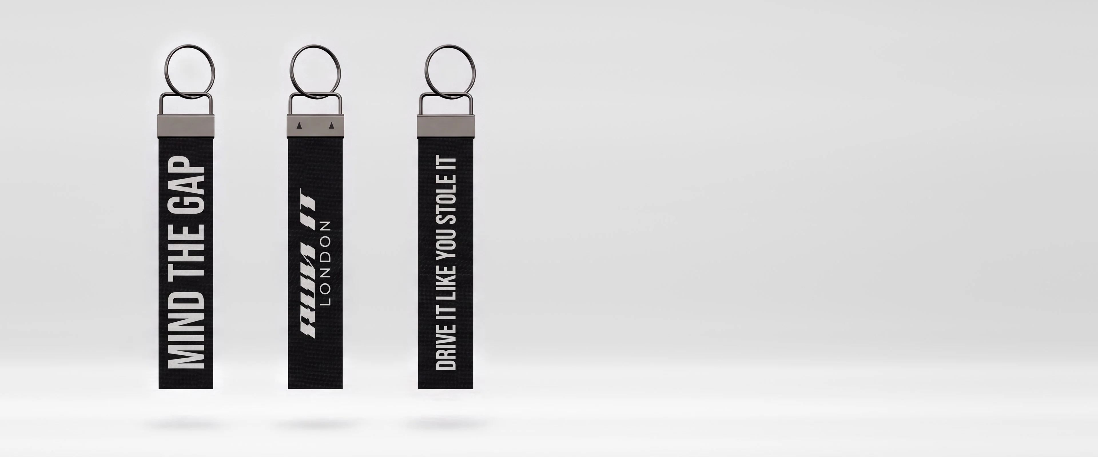 RUN IT LONDON keychains: MIND THE GAP and DRIVE IT LIKE YOU STOLE IT either side of a keychain's back with the RUN IT LONDON logo
