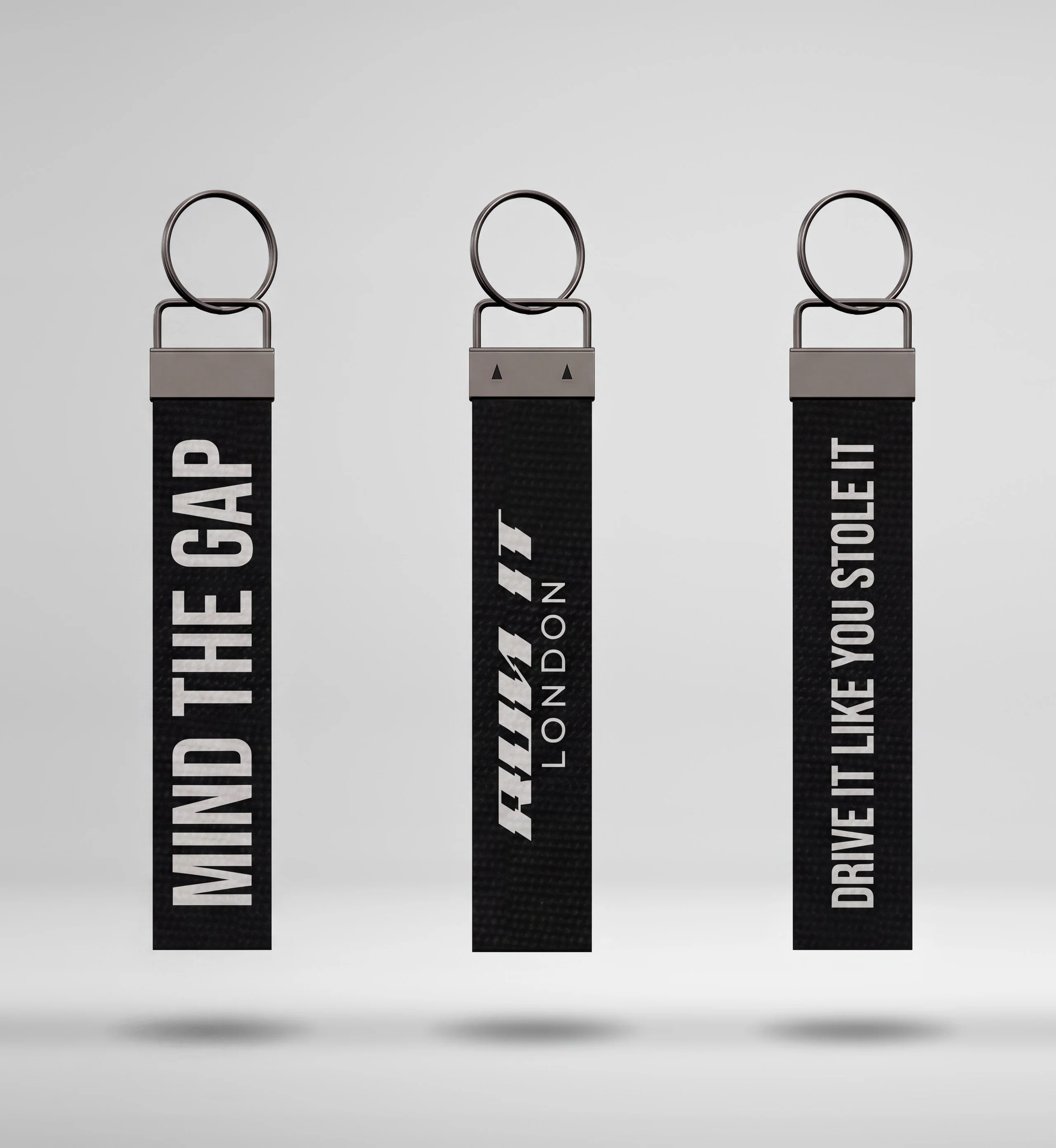 RUN IT LONDON keychains: MIND THE GAP and DRIVE IT LIKE YOU STOLE IT either side of a keychain's back with the RUN IT LONDON logo