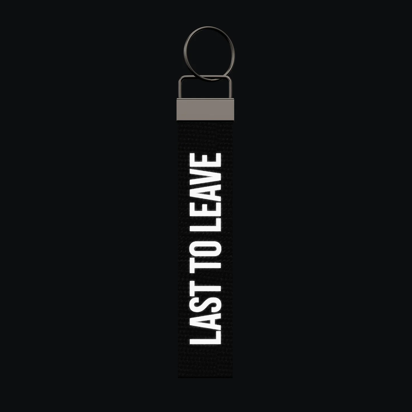 LAST TO LEAVE Keychain, reflective print lit up by a camera flash