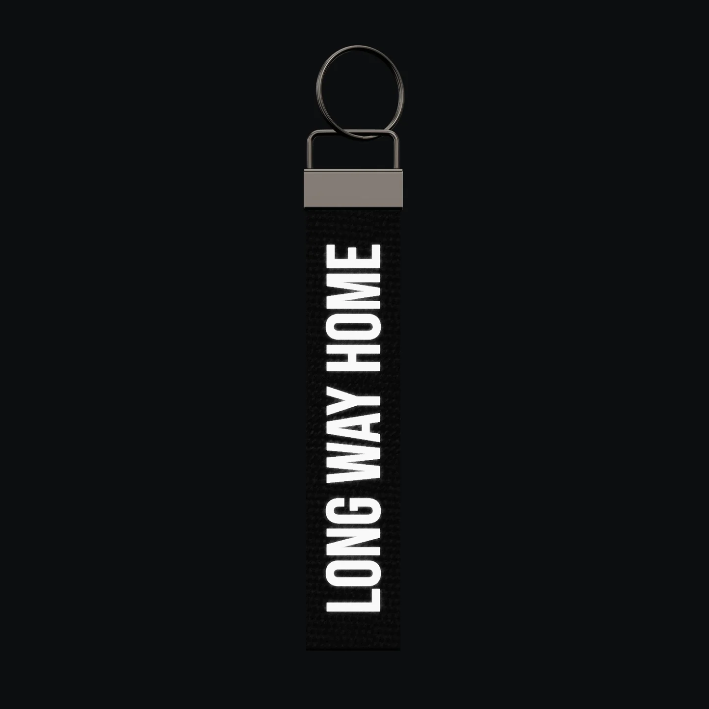LONG WAY HOME Keychain, reflective print lit up by a camera flash