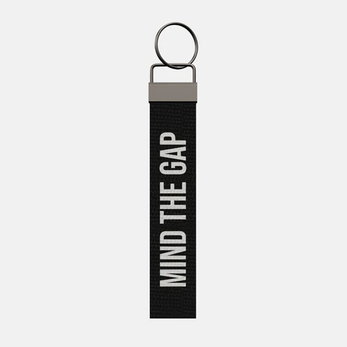 MIND THE GAP Keychain, front: MIND THE GAP in white print