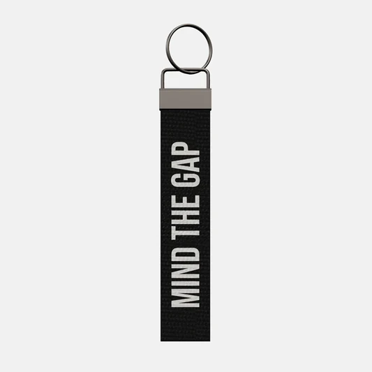 MIND THE GAP Keychain, front: MIND THE GAP in white print