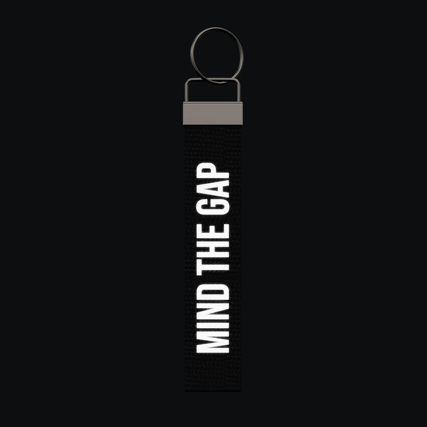 MIND THE GAP Keychain, reflective print lit up by a camera flash