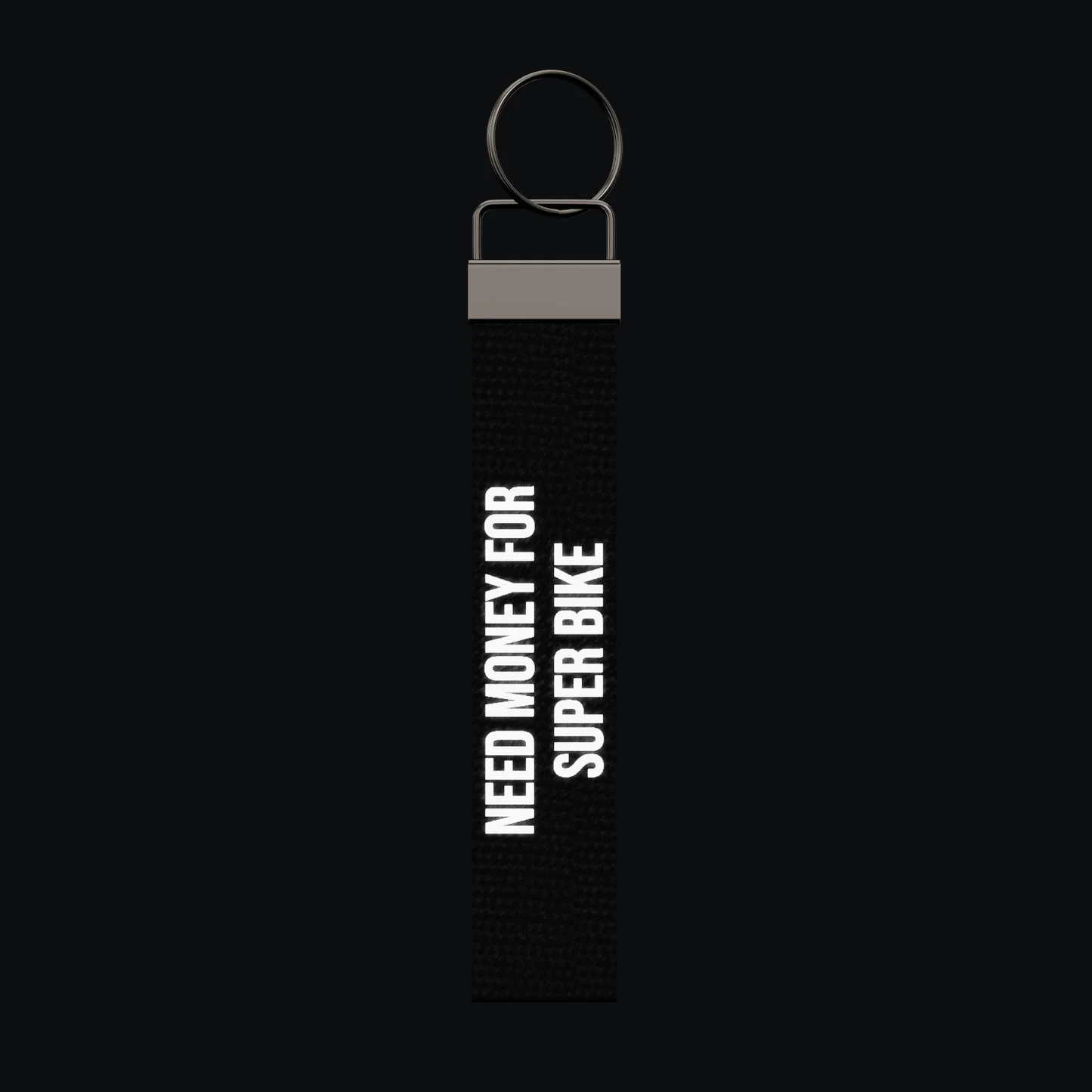 NEED MONEY FOR SUPER BIKE Keychain, reflective print lit up by a camera flash