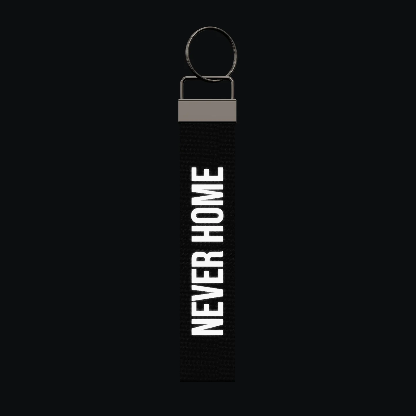 NEVER HOME Keychain, reflective print lit up by a camera flash