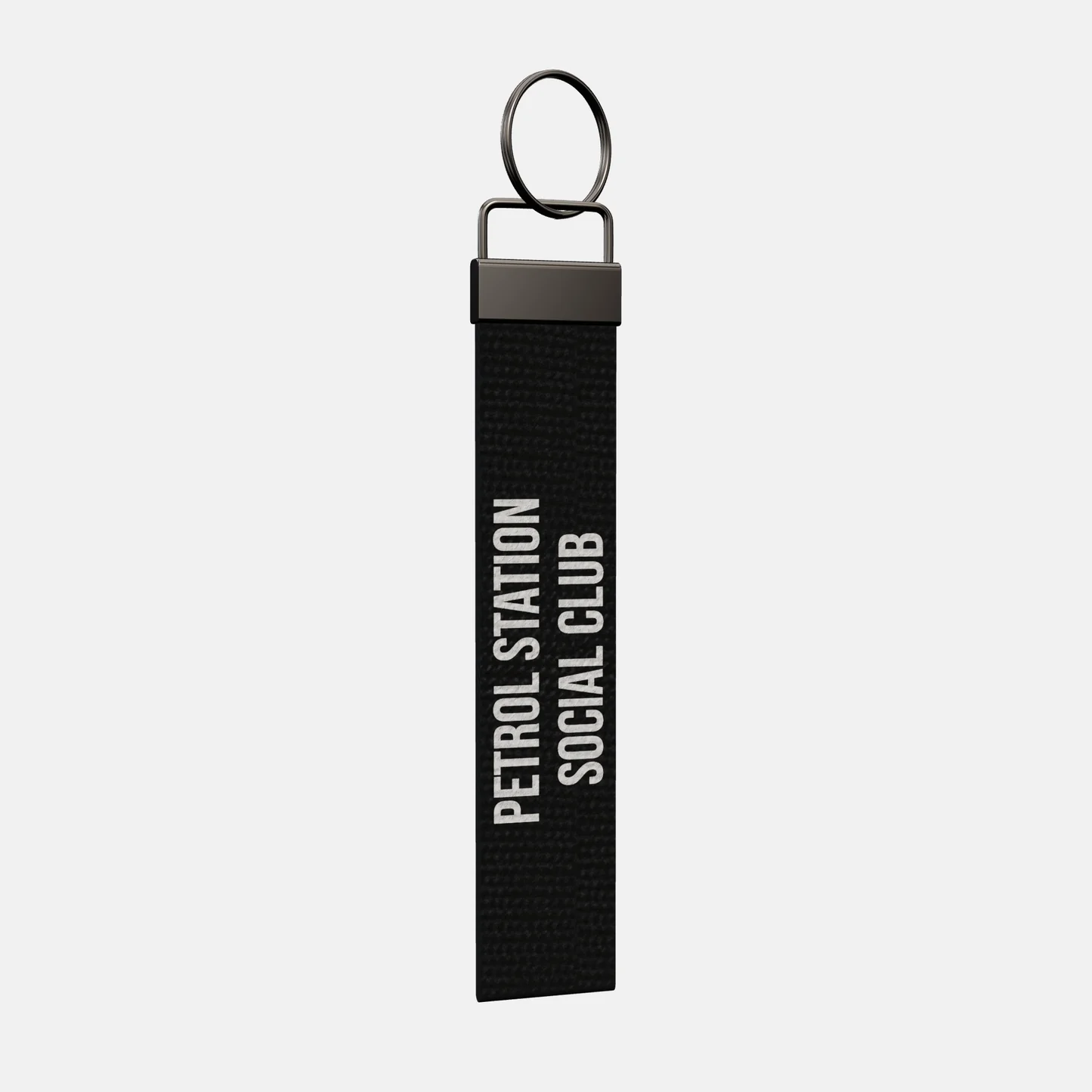 PETROL STATION SOCIAL CLUB Keychain at an angle, black-nickel clamp and split ring