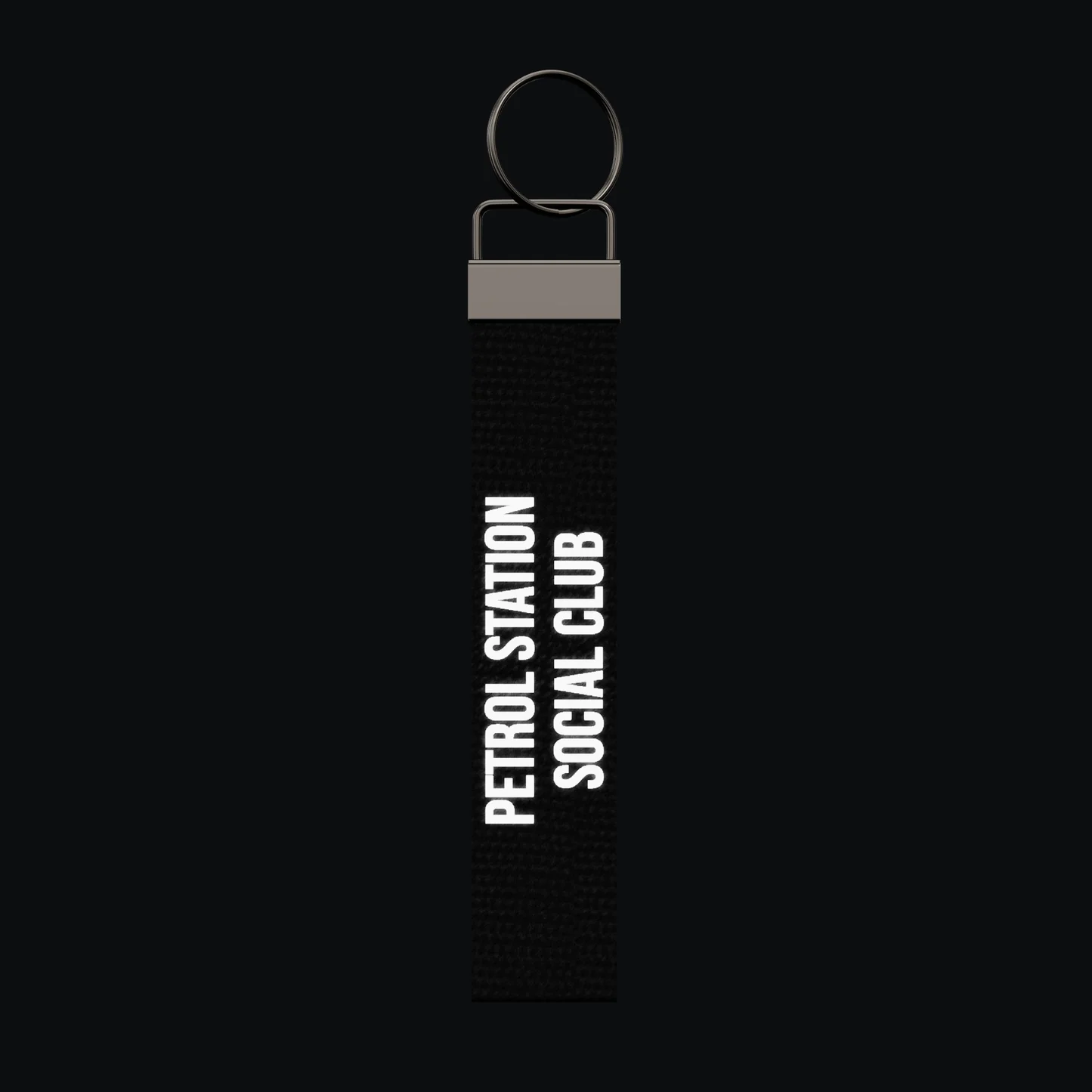 PETROL STATION SOCIAL CLUB Keychain, reflective print lit up by a camera flash