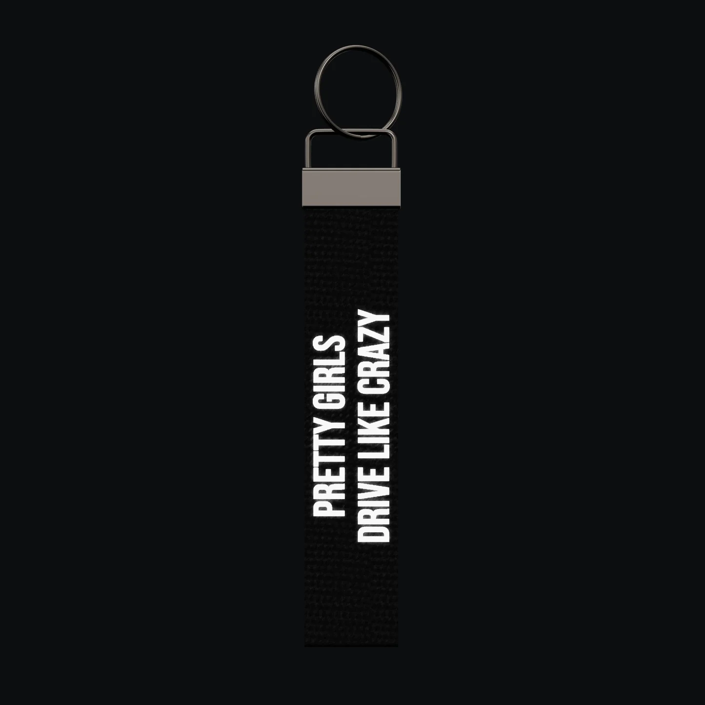 PRETTY GIRLS DRIVE LIKE CRAZY Keychain, reflective print lit up by a camera flash