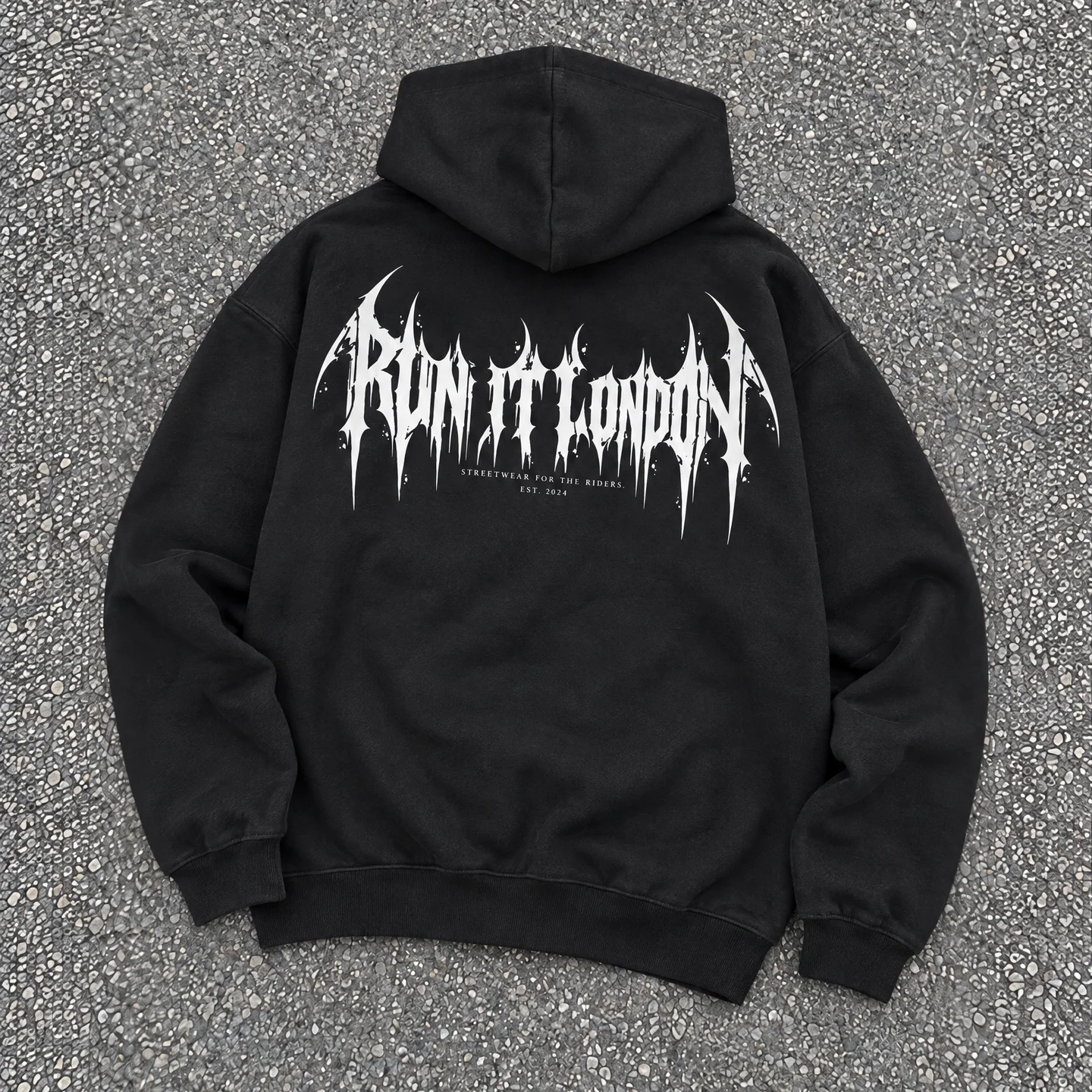 CYBERSIGIL Hoodie — black hoodie back print laid flat on grey aggregate floor
