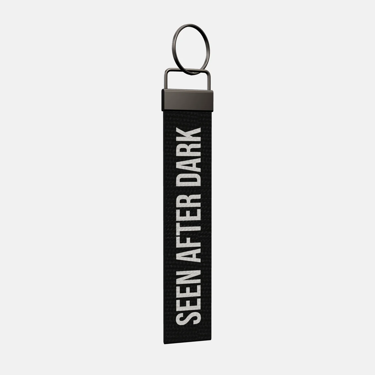 SEEN AFTER DARK Keychain at an angle, black-nickel clamp and split ring
