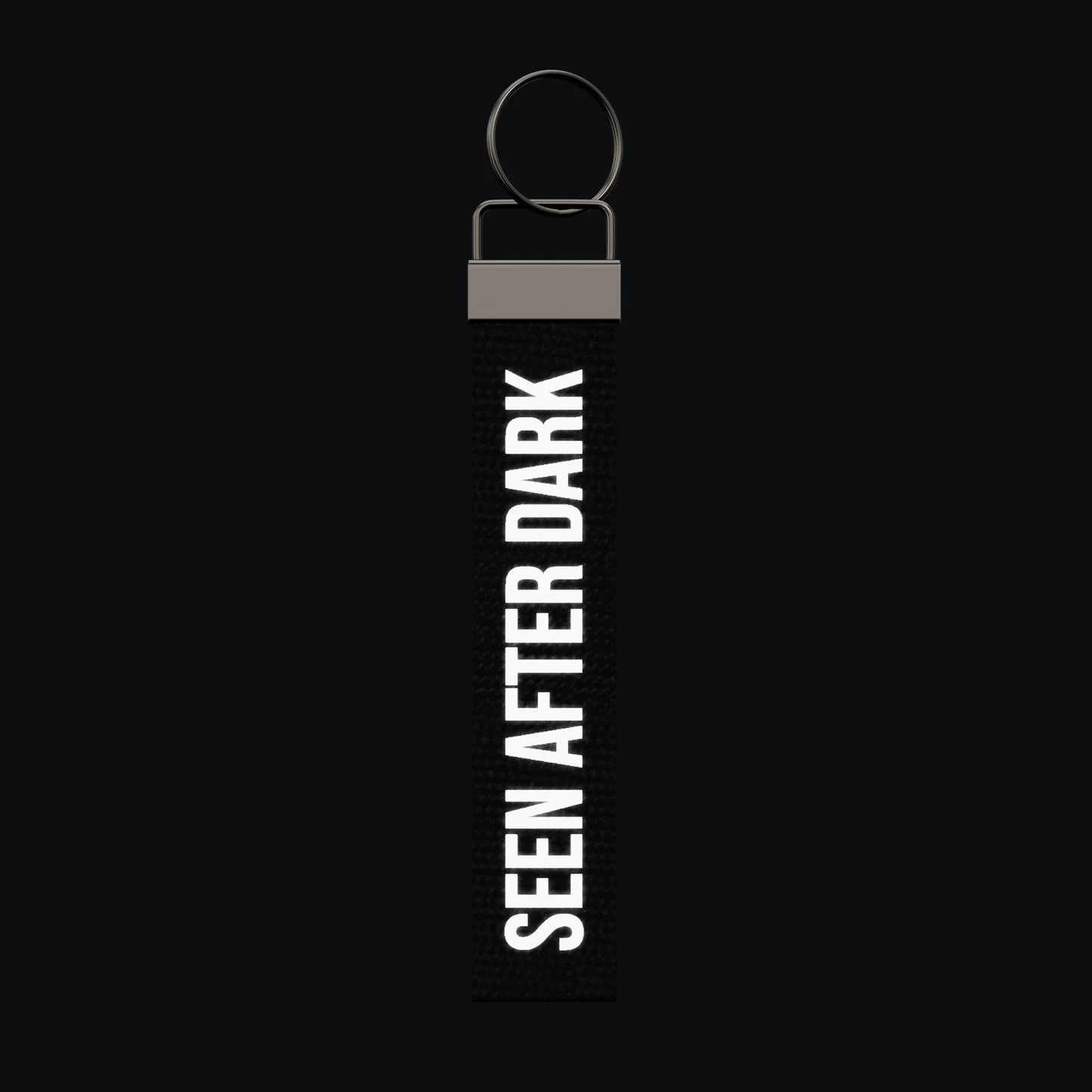 SEEN AFTER DARK Keychain, reflective print lit up by a camera flash