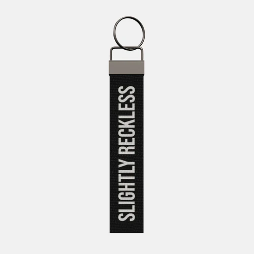 SLIGHTLY RECKLESS Keychain, front: SLIGHTLY RECKLESS in white print