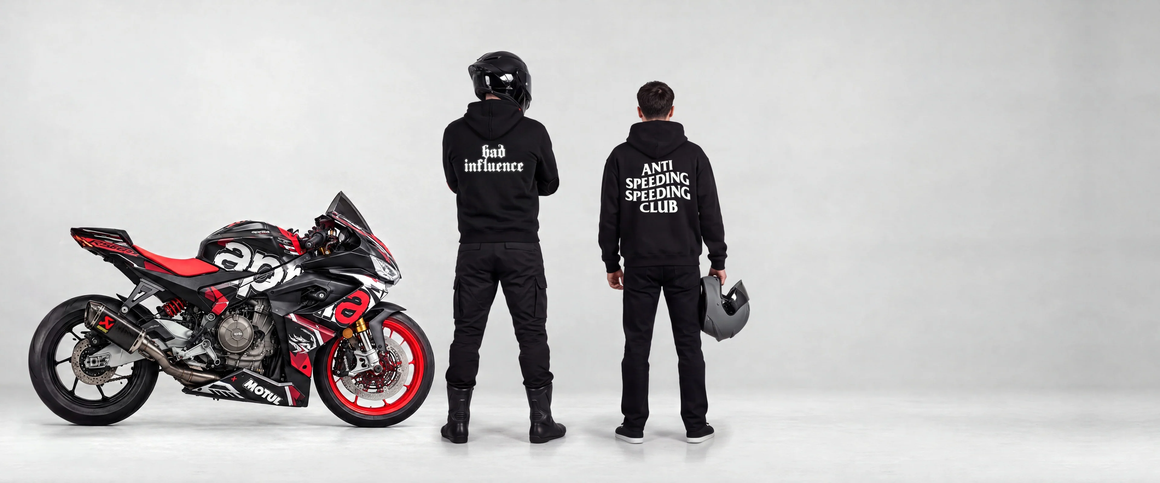 Two riders in RUN IT LONDON hoodies next to a sportbike