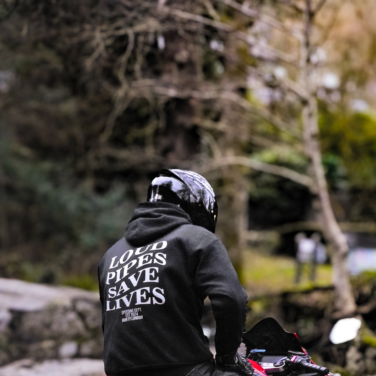 Rider wearing the LOUD PIPES SAVE LIVES Hoodie, back print