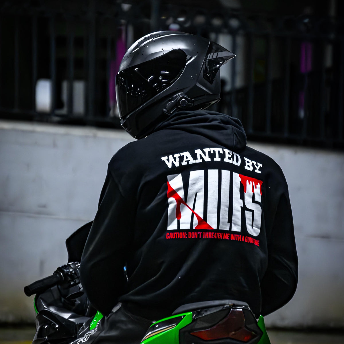 Rider wearing the WANTED BY MILFS Hoodie, back print